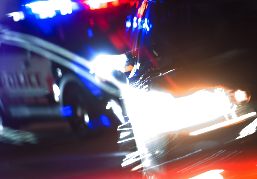 blurry image of a car getting pulled over by a police officer
